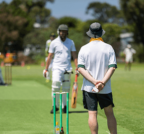 Young woman playing cricket outdoors