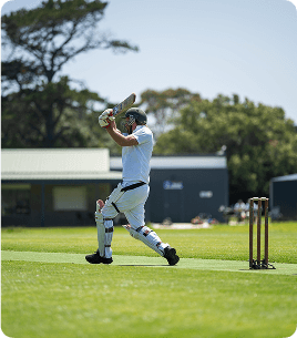Cricket bat and ball on field